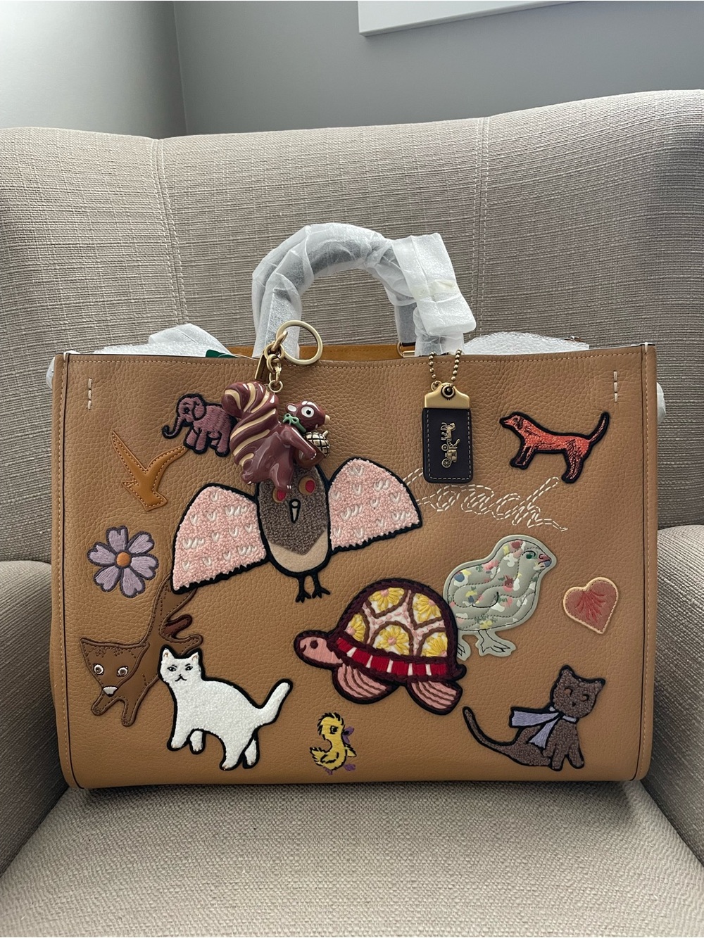 Coach Rogue 39 bag With Creature Patches in colour light tan multi NWT